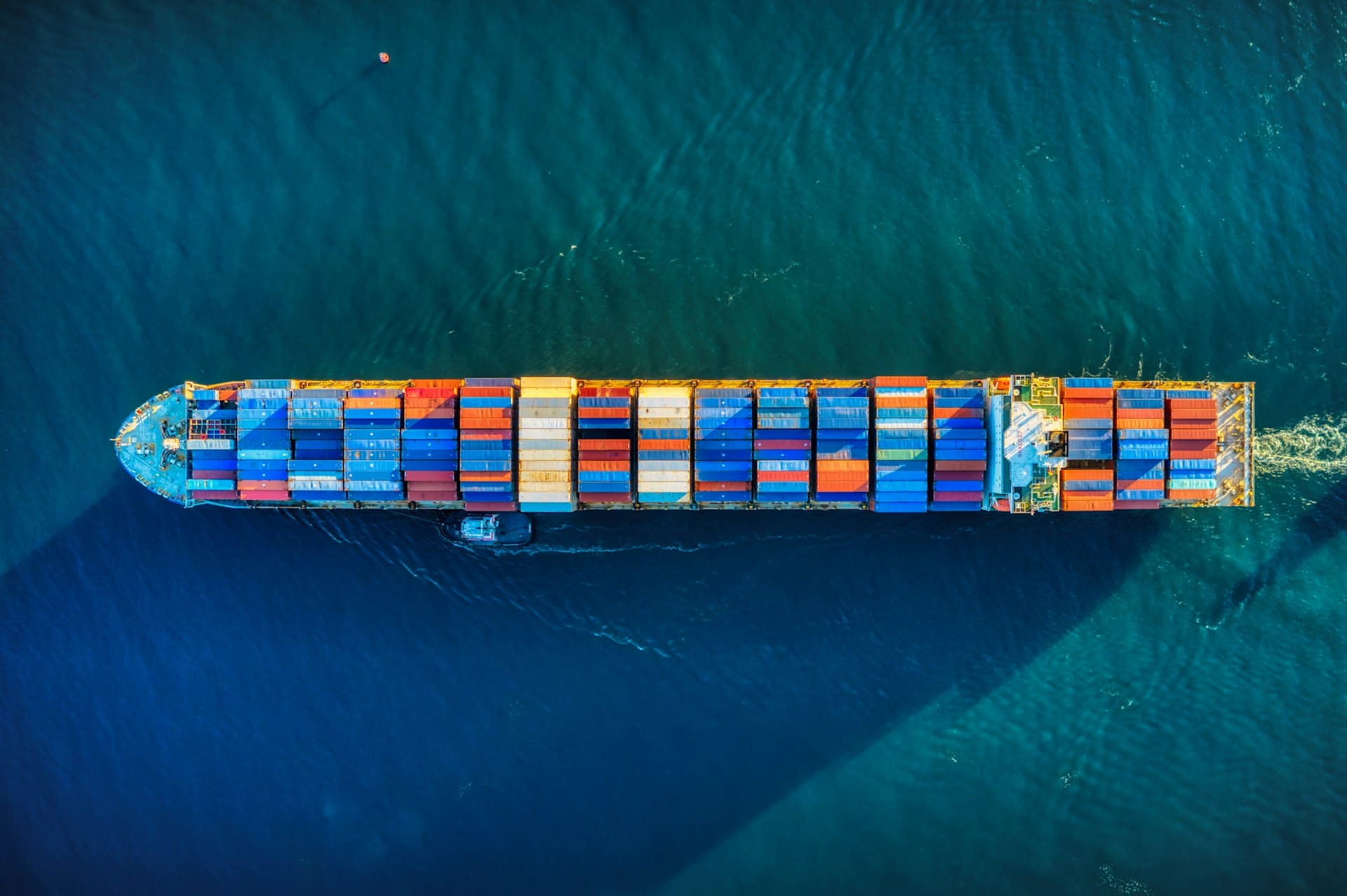 Aerial view of a cargo ship. With lots of colorfull containers on the calm ocean.