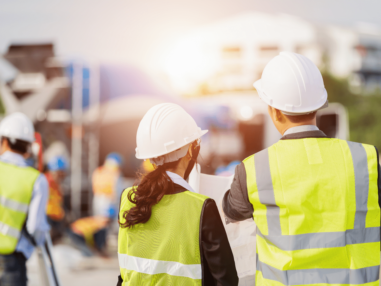 A man and woman in hi-vis vests at a construction site